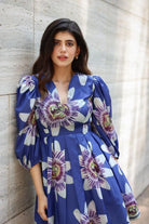 Sanjana Sanghi wearing the Amara Mini Dress, a women's cobalt blue cotton satin mini dress featuring a vibrant printed design, a relaxed swing silhouette and a flattering above-the-knee length, styled for summer brunches, resort vacations, holiday outings and casual celebrations.