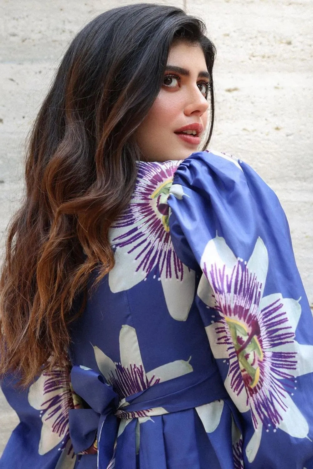 Sanjana Sanghi wearing the Amara Mini Dress, a women's cobalt blue cotton satin mini dress featuring a vibrant printed design, a relaxed swing silhouette and a flattering above-the-knee length, styled for summer brunches, resort vacations, holiday outings and casual celebrations.