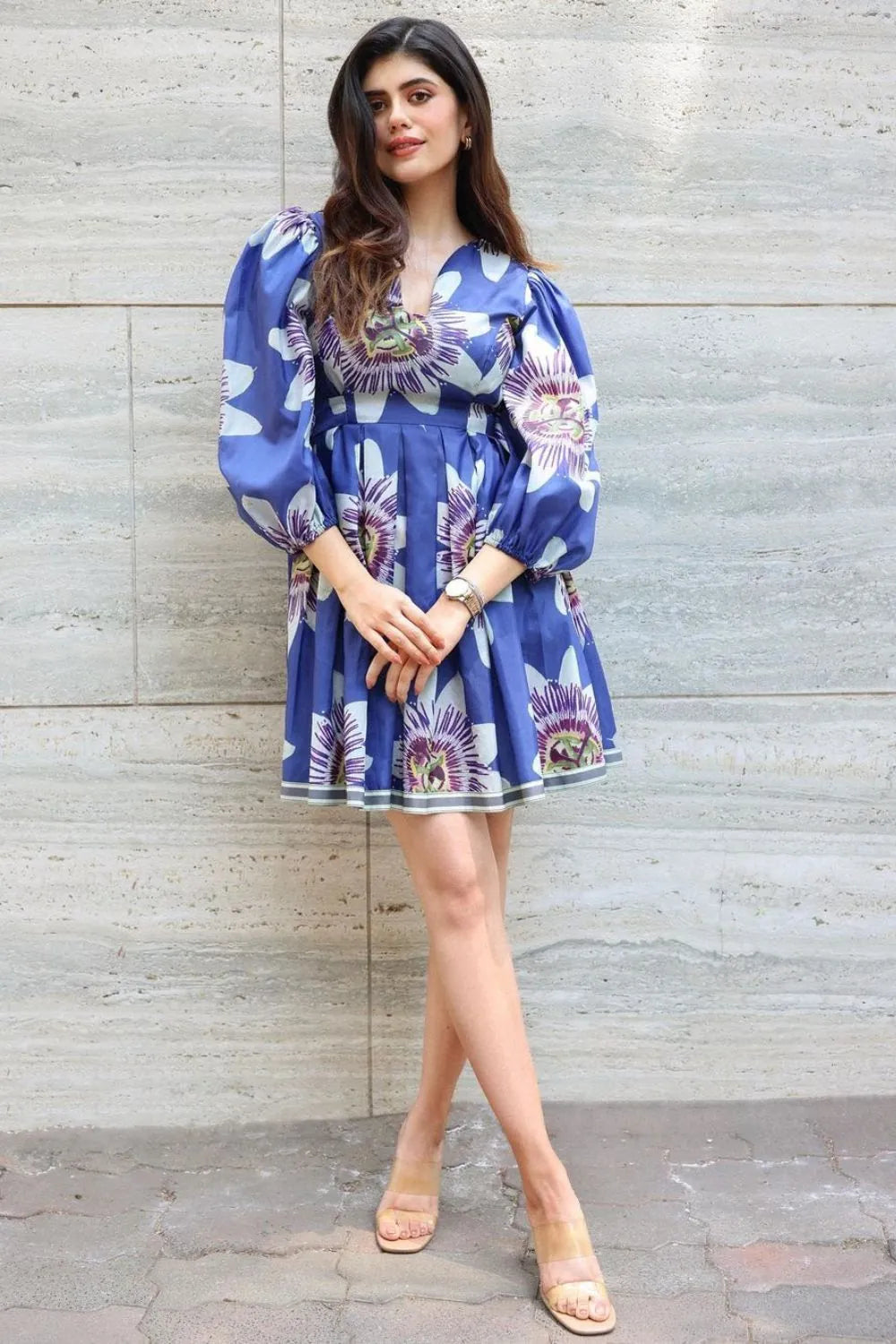 Sanjana Sanghi wearing the Amara Mini Dress, a women's cobalt blue cotton satin mini dress featuring a vibrant printed design, a relaxed swing silhouette and a flattering above-the-knee length, styled for summer brunches, resort vacations, holiday outings and casual celebrations.