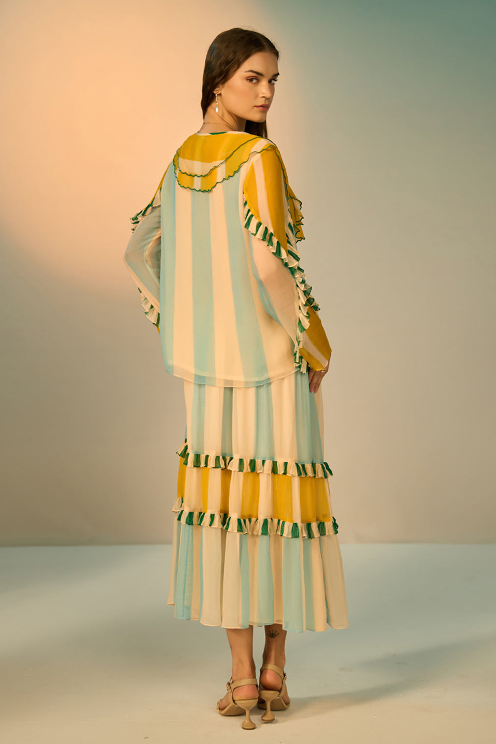 Woman wearing a colorful dress with a neutral background